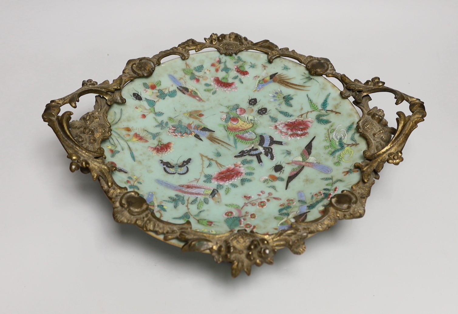 An ormolu-mounted Chinese celadon ground famille rose serving dish. 25cm wide